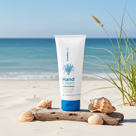 Hand cream tube on a beach with shells and grass